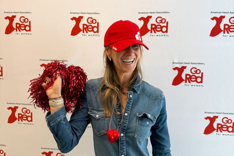 Cristina holding pom pom at Go Red for Women event