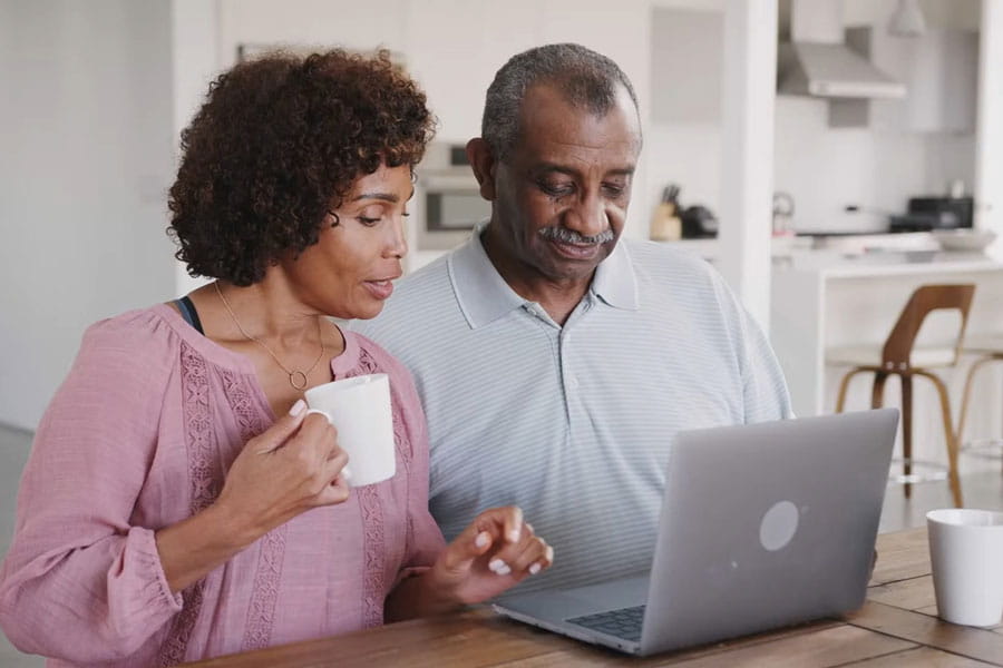 Couple on laptop browsing the Support Network